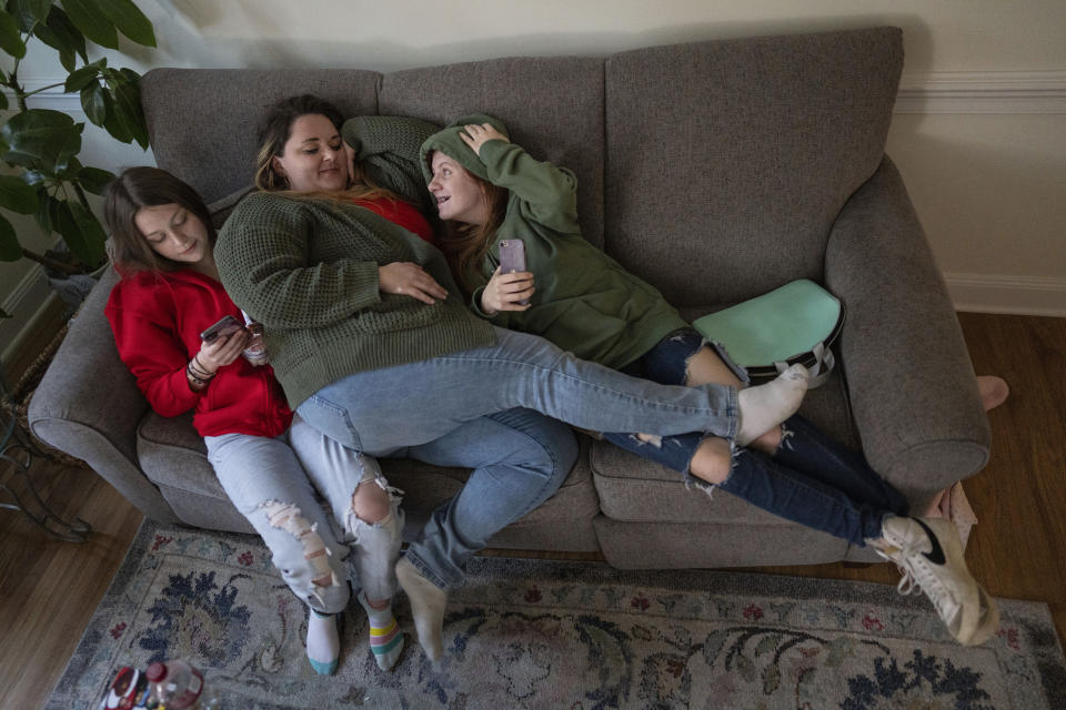 CORRECTS NAME TO ADESSA - Heather Jarvis, center, spends the day with her daughter Adessa, 17, left, and niece Layla, 14, for a holiday party in Columbus, Ohio, Thursday, Dec. 21, 2023. Jarvis is part of the fastest-growing prison population in the country, one of more than 190,000 women held in some form of confinement in the United States as of this year. Their numbers grew by more than 500% between 1980 and 2021. (AP Photo/Carolyn Kaster)