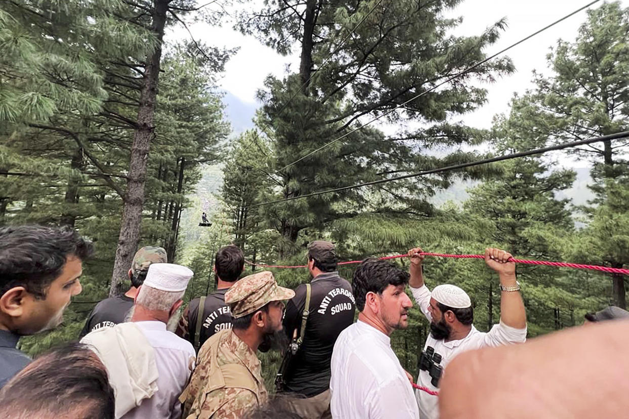 Army commandos using helicopters and a makeshift chairlift rescued eight people from a broken cable car dangling hundreds of meters (feet) above a canyon Tuesday in a remote part of Pakistan, authorities said.  (Inter Services Public Relation / via AP)