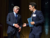 FILE - In this Oct. 13, 2016 file photo Columbia University President Lee Bollinger, left, reaches out to Lin-Manuel Miranda, who was recognized for the Pulitzer Prize in Drama for "Hamilton," during the Pulitzer Prize awards at Columbia University in New York. Miranda, who was everywhere in popular culture this year, was named The Associated Press Entertainer of the Year, voted by members of the news cooperative. (AP Photo/Craig Ruttle, File)