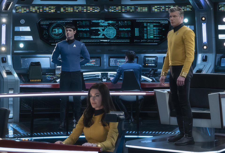 This image released by CBS All Access shows, from left, Ethan Peck as Spock, Rebecca Romijn as Number One, and Anson Mount as Captain Pike of the the CBS All Access series "Star Trek: Strange New Worlds." CBS All Access is bringing back Spock for its third full live action show in the “Star Trek” universe, ordering a new series set in the years before Capt. James T. Kirk helmed the U.S.S. Enterprise. (Michael Gibson/CBS via AP)