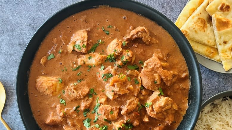 butter chicken in black bowl