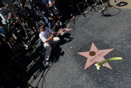 Flowers are placed on Dick Clark's Hollywood Walk of Fame Star in Hollywood, California. Clark, who hosted "American Bandstand", died of a massive heart attack at age 82