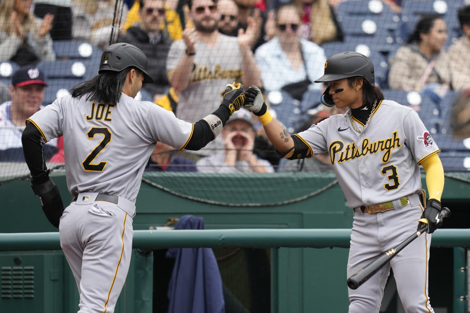 Pittsburgh Pirates' Connor Joe, left, fist bumps teammate Ji Hwan Bae after scoring on Miguel Andujar's single in the second inning of the first baseball game of a doubleheader against the Washington Nationals, Saturday, April 29, 2023, in Washington. (AP Photo/Patrick Semansky)
