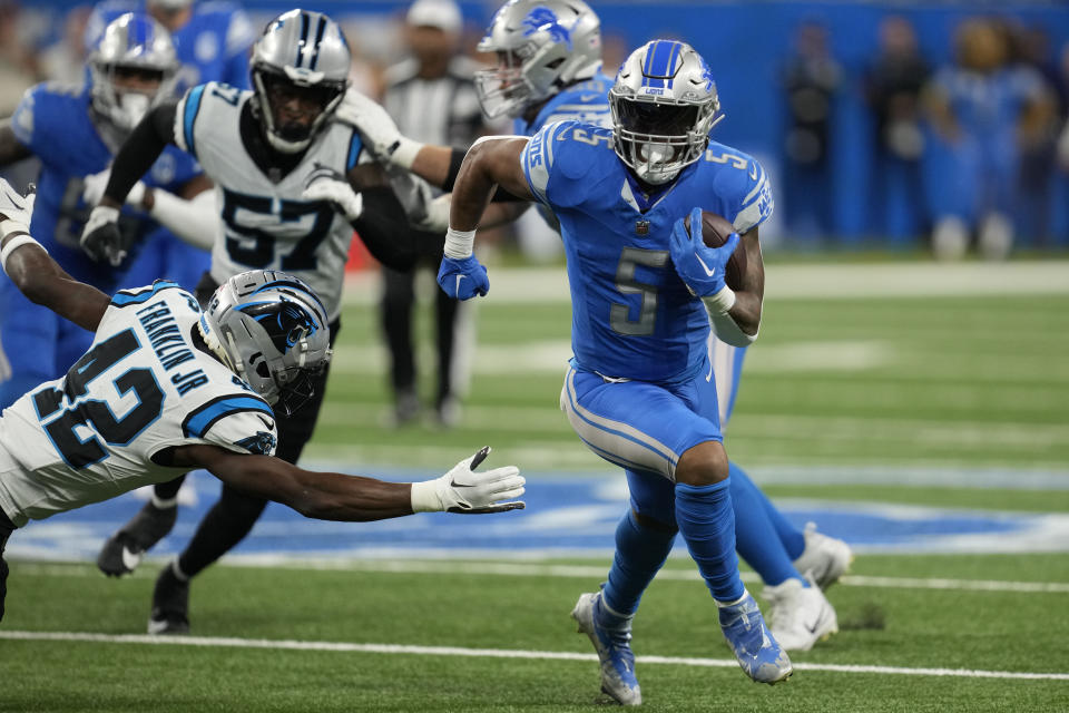 Detroit Lions running back David Montgomery (5) carries for a touchdown around Carolina Panthers safety Sam Franklin Jr. (42) in the first half of an NFL football game in Detroit, Sunday, Oct. 8, 2023. (AP Photo/Paul Sancya)
