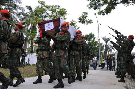 Members of the Indonesian Air Force carry the coffin of Sergeant Sugiyanto, who was killed in the crash of an Air Force transport plane in Medan, at a cemetery in Pekanbaru, Riau, Indonesia July 2, 2015 in this photo taken by Antara Foto. REUTERS/FB Anggoro/Antara Foto
