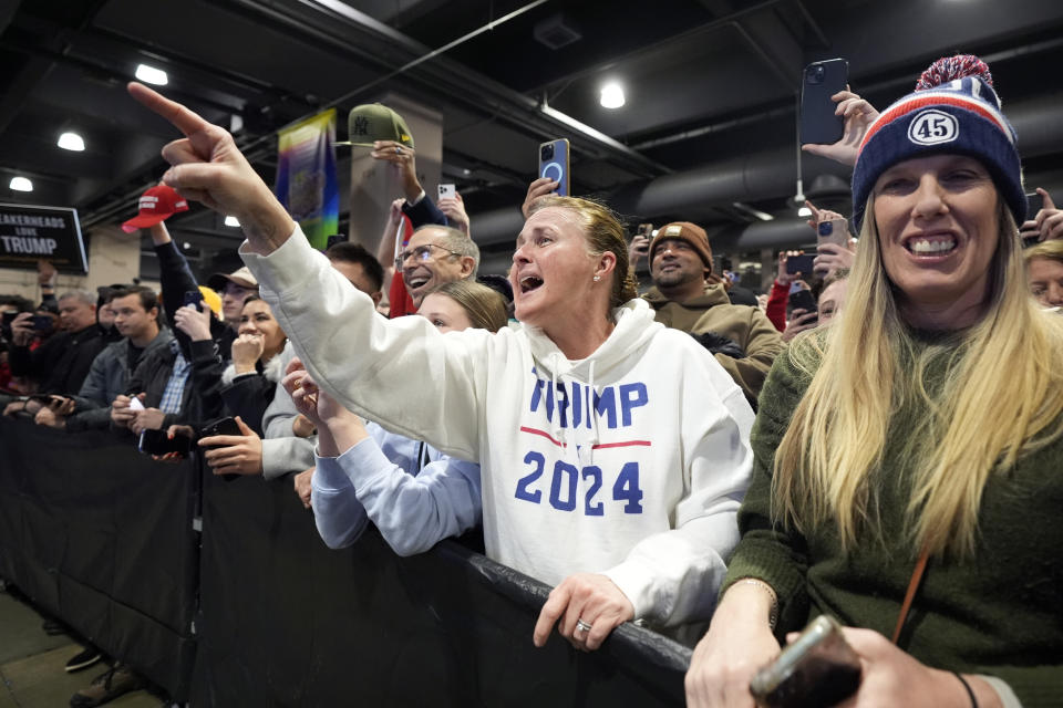 Supporter Donna Bernhard of Adamstown, Pa., points at Republican presidential candidate former President Donald Trump at Sneaker Con Philadelphia, an event popular among sneaker collectors, in Philadelphia, Saturday, Feb. 17, 2024. Trump brought her up on stage. (AP Photo/Manuel Balce Ceneta)