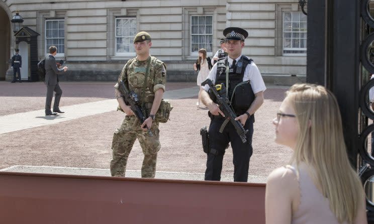 An armed soldier and policeman outside Buckingham Palace (Rex)