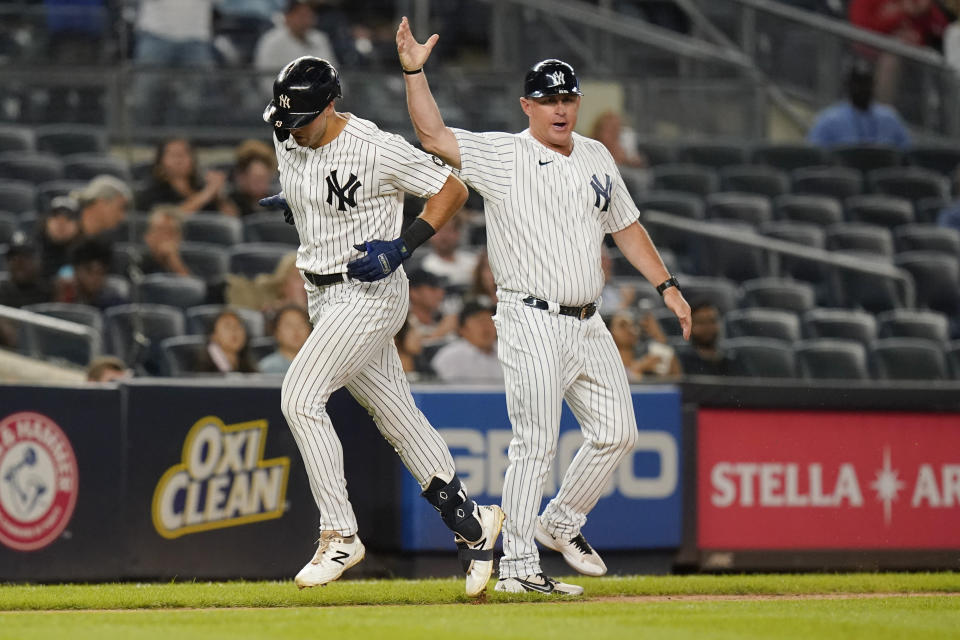 New York Yankees' Phil Nevin, right, celebrates with New York Yankees' Joey Gallo as he runs the bases after hitting a home run during the sixth inning of a baseball game against the Texas Rangers Tuesday, Sept. 21, 2021, in New York. (AP Photo/Frank Franklin II)