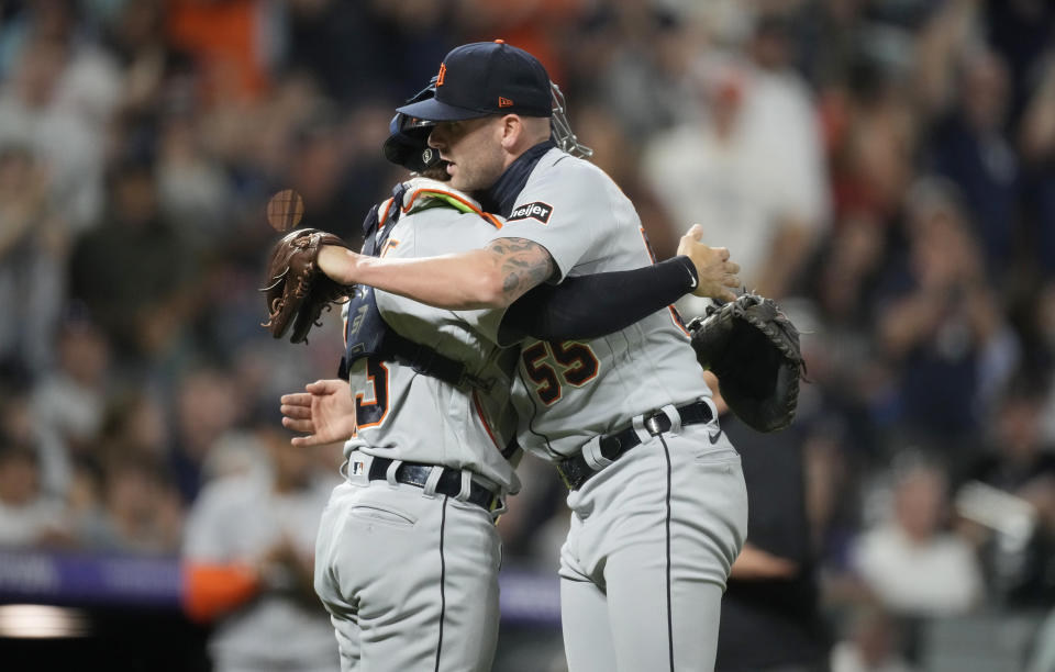 Detroit Tigers catcher Eric Haase, left, hugs relief pitcher Alex Lange, who struck out Colorado Rockies' Ryan McMahon in the 10th inning to end a baseball game Saturday, July 1, 2023, in Denver. (AP Photo/David Zalubowski)