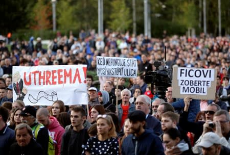 Demonstrators attend an anti-government protest rally in reaction to last year's killing of the investigative reporter Jan Kuciak and his fiancee Martina Kusnirova in Bratislava