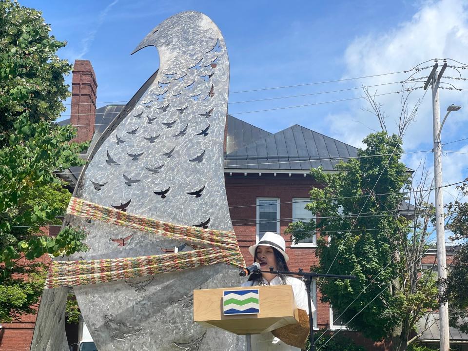 Artist Ai Qiu Hopen speaks about the meaning of her sculpture "Embrace and Belonging" at its unveiling in Dewey Park, June 26, 2024.