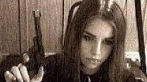 A blurry image of Jasmine Richardson holding a gun