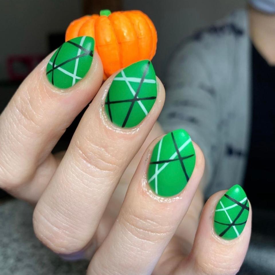 Nails don't need to be long to look fierce with a pointed tip or vibrant nail art, as evidenced by this bold manicure by Walker. The vibrant kelly green and sharp tips have a witchy vibe (Halloween <em>is</em> just around the corner, after all), but it avoids feeling too themed, thanks to thin black-and-white stripes in random directions.