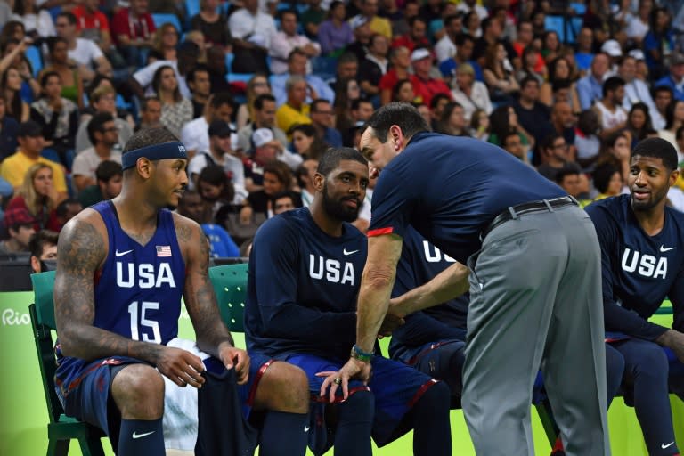USA's head coach Mike Krzyzewski (front R) talks with forward Carmelo Anthony (L), guards Kyrie Irving (C) and Paul George on the bench