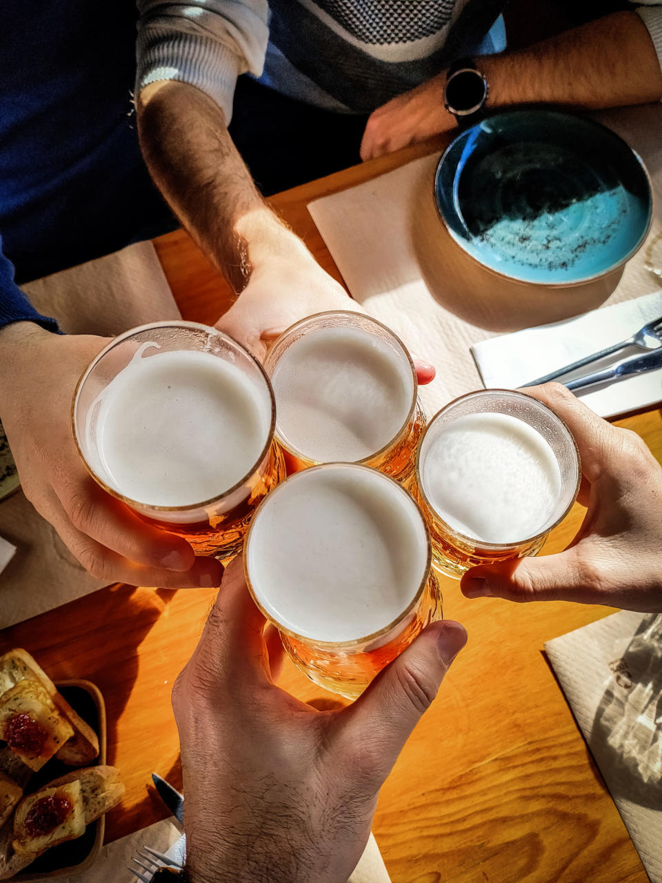 Top view group of friends toast with glasses of beer.