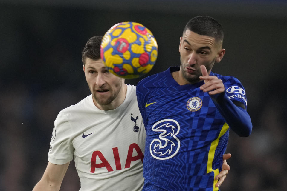 Chelsea's Hakim Ziyech, right, jumps for the ball with Tottenham's Ben Davies during the English Premier League soccer match between Chelsea and Tottenham Hotspur at Stamford Bridge stadium in London, England, Sunday, Jan. 23, 2022. (AP Photo/Kirsty Wigglesworth)