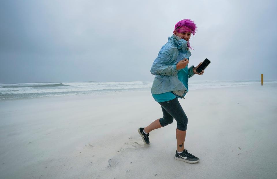 Courtney Watts, of Tuscaloosa, Ala., moves off the beach at Gulf State Park on Sept. 15, 2020, in Gulf Shores, Ala.