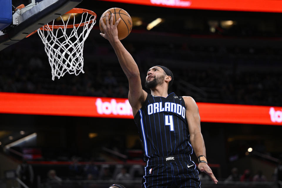 Orlando Magic guard Jalen Suggs (4) goes up to shoot during the first half of an NBA basketball game against the Charlotte Hornets, Tuesday, March 19, 2024, in Orlando, Fla. (AP Photo/Phelan M. Ebenhack)
