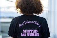 Andrea, no last name given, who works as a stripper in Seattle area clubs, poses for a portrait at her apartment, Thursday, Feb. 1, 2024, in Seattle. Andrea is among those fighting for bills to pass in the state Legislature that would expand statewide protections to workers, like having a security guard at each club, keypad codes to enter dressing rooms and de-escalation training. (AP Photo/Lindsey Wasson)