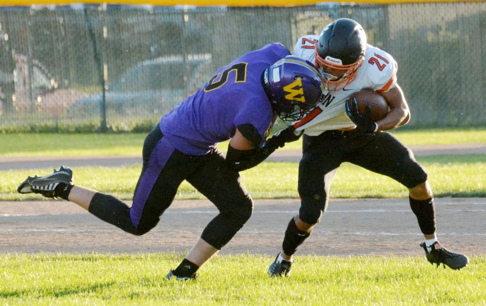 Watertown's Simon Hendricks brings down Huron's Quinston Luellman Clark in the backfield during their Eastern South Dakota Conference football game Friday night at Watertown Stadium. The Arrows won 34-19.