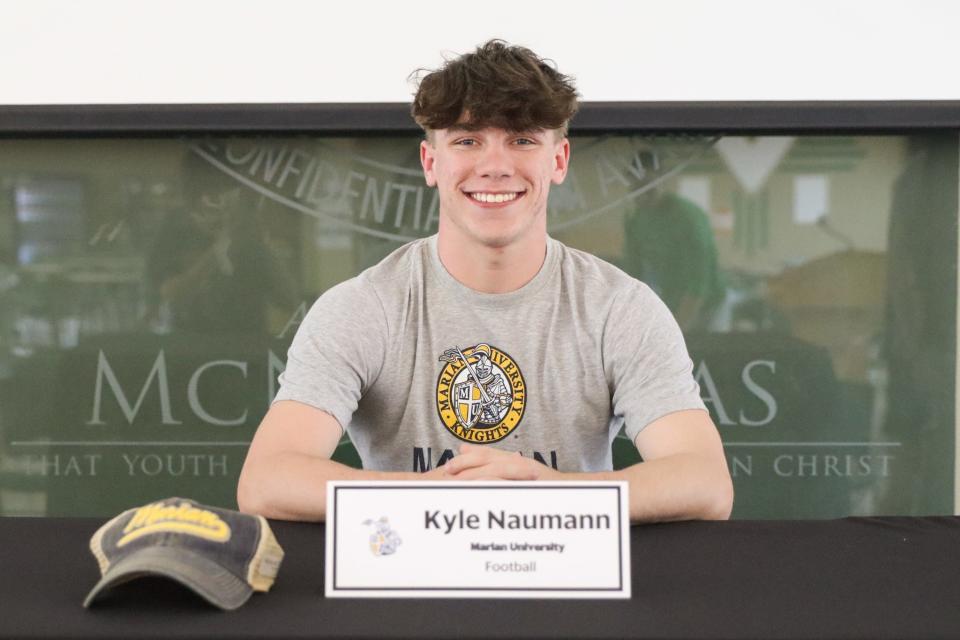 Kyle Naumann of McNicholas signed his letter of intent to play football with Marian University April 17, 2024, at McNicholas.