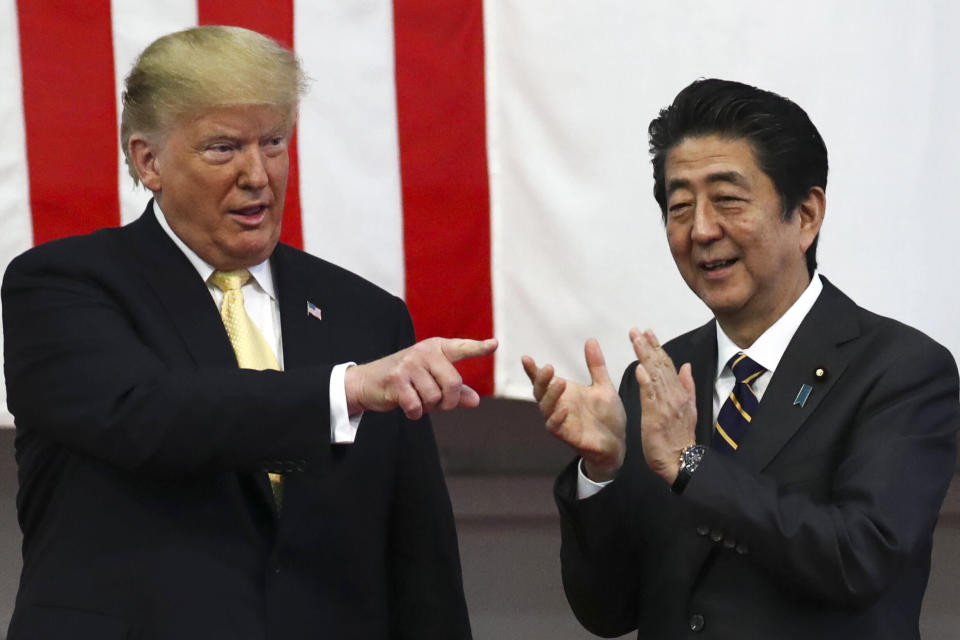 U.S. President Donald Trump, left, and Japan's Prime Minister Shinzo Abe react during delivering a speech to Japanese and U.S. troops as they aboard Japan Maritime Self-Defense Force's (JMSDF) helicopter carrier DDH-184 Kaga at JMSDF Yokosuka base in Yokosuka, south of Tokyo Tuesday, May 28, 2019. (Athit Perawongmetha/Pool Photo vi AP)