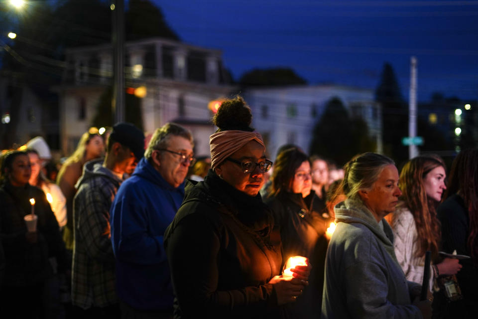 People gather at a vigil for the victims of Wednesday's mass shootings, Sunday, Oct. 29, 2023, outside the Basilica of Saints Peter and Paul in Lewiston, Maine. (AP Photo/Matt Rourke)