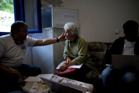 A volunteer doctor of the Aegean Team examines a local woman on the islet of Thymaina, Greece, May 11, 2017. REUTERS/Alkis Konstantinidis