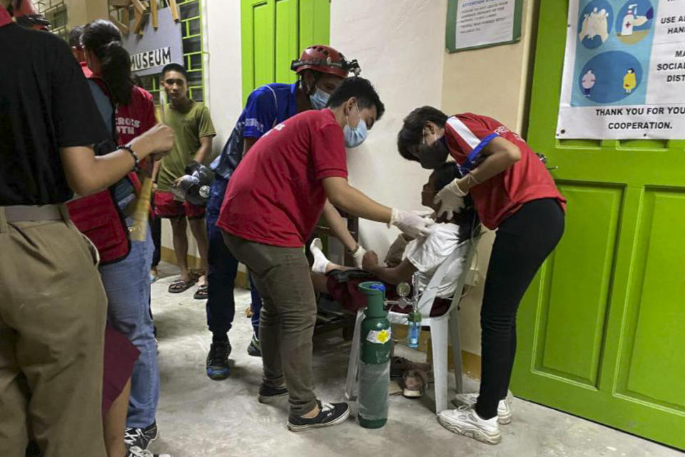 In this handout photo provided by the Philippine Red Cross, volunteers attend to people affected by an earthquake that struck Koronadal, South Cotabato, southern Philippines on Friday Nov. 17, 2023. A powerful undersea earthquake has shaken the southern Philippines. The U.S. Geological Survey says the quake measured magnitude 6.7 and was located 26 kilometers (16 miles) from Burias at the southern tip of the Philippines. (Philippine Red Cross via AP)