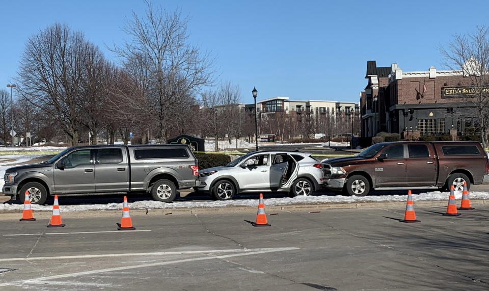 Quadren Wilson's silver sedan is wedged between two SUVs at the scene of a shooting on Feb. 3, 2022, in Madison, Wis. A prosecutor charged a Wisconsin Department of Justice agent on Thursday, Sept. 22, 2022, with reckless endangerment in the nonfatal shooting of Wilson during a Madison traffic stop last winter. (Chris Rickert/Wisconsin State Journal via AP)