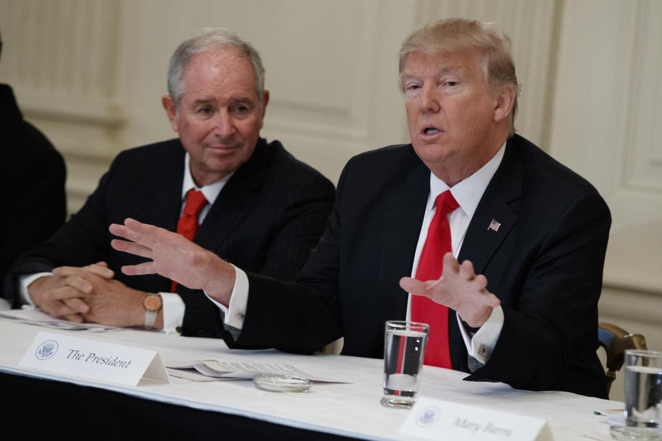 Blackstone CEO Stephen Schwarzman listens at left as President Donald Trump speaks during a meeting with business leaders in the State Dining Room of the White House in Washington, Friday, Feb. 3, 2017. (AP Photo/Evan Vucci)