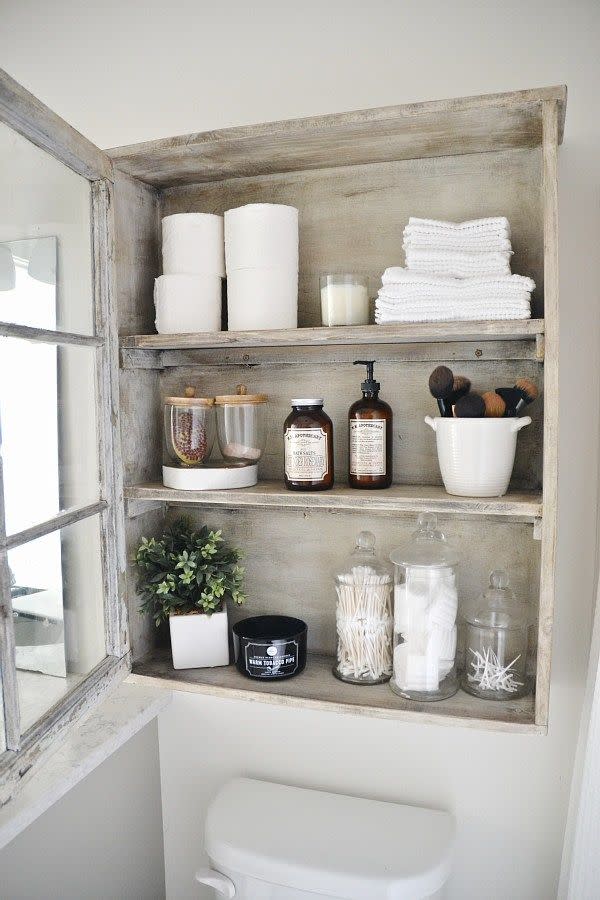 bathroom shelf ideas, an open antique storage cabinet in the bathroom with shelves full of organized products