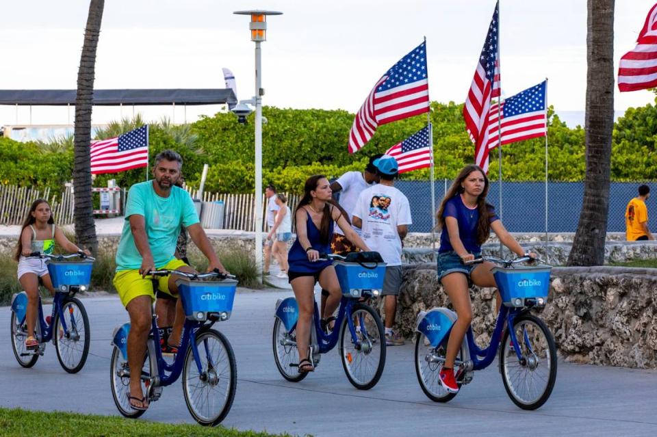 A group of bicyclists pedal down the beach boardwalk during the first day of Memorial Day Weekend in Miami Beach, Florida, on Friday, May 27, 2022.
