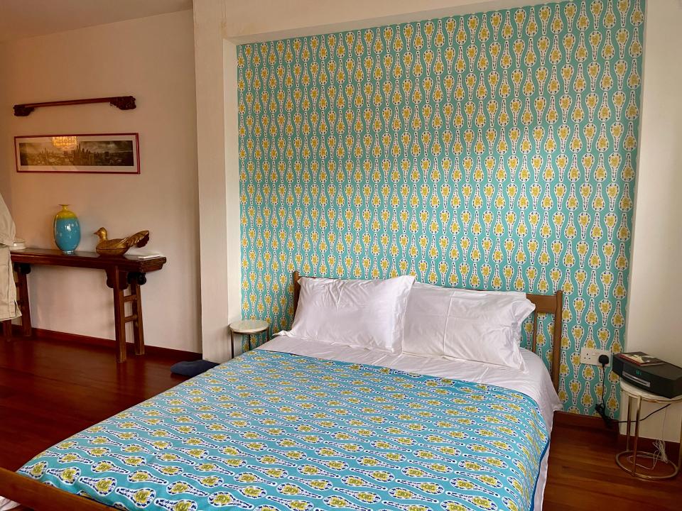 The guest bedroom with custom wallpaper and matching sheets.