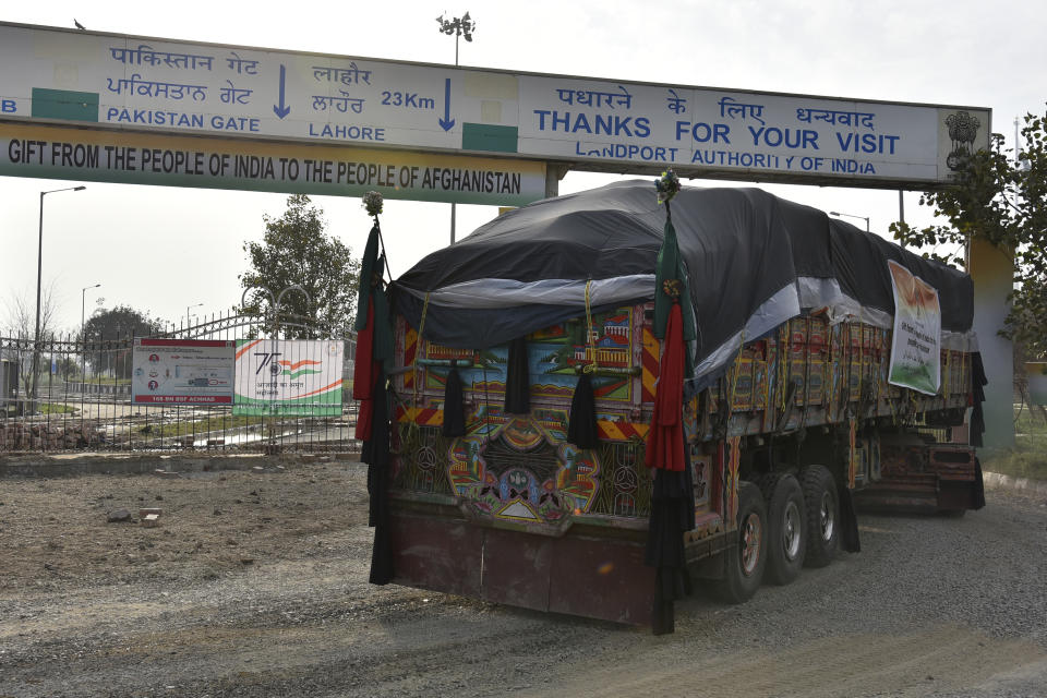 A truck carrying wheat from India passes through the Attari-Wagah border between India and Pakistan, near Amritsar, India, Tuesday, Feb. 22, 2022. India's foreign ministry says it has sent off tons of wheat to Afghanistan to help relieve desperate food shortages, after New Delhi struck a deal with neighboring rival Pakistan to allow the shipments across the shared border. (AP Photo/Prabhjot Gill)