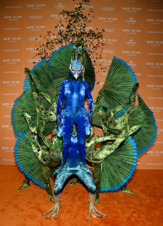 Heidi Klum, center, in blue, arrives at her 22nd annual Halloween party at Marquee on Tuesday, Oct. 31, 2023, in New York. (Photo by Evan Agostini/Invision/AP)