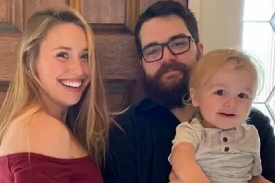 <p>GoFundMe</p> Parents Adam and Chelsey Warren posing with their son Lucas, who died in floodwaters on May 5