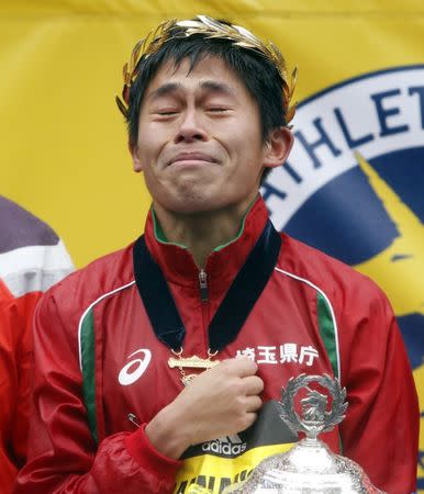 Apr 16, 2018; Boston, MA, USA; Yuki Kawauchi of Japan closes his eyes as he listens to his National Anthem after winning the 2018 Boston Marathon. Mandatory Credit: Winslow Townson-USA TODAY Sports