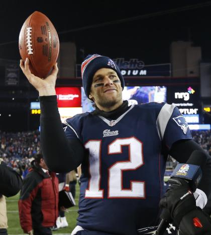 Tom Brady holds up the game ball after Saturday's back-and-forth AFC divisional game. (AP)