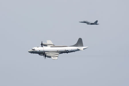 FILE PHOTO: A U.S. Navy EP-3E Aries signals reconnaissance aircraft, escorted by an EA-18G Growler electronic warfare aircraft, performs a flyby over aircraft carrier USS Harry S. Truman in the Arabian Gulf April 24, 2016. U.S. Navy/Mass Communication Specialist 3rd Class Bobby J Siens/Handout/File Photo via REUTERS. ATTENTION EDITORS - THIS IMAGE IS PROVIDED BY A THIRD PARTY