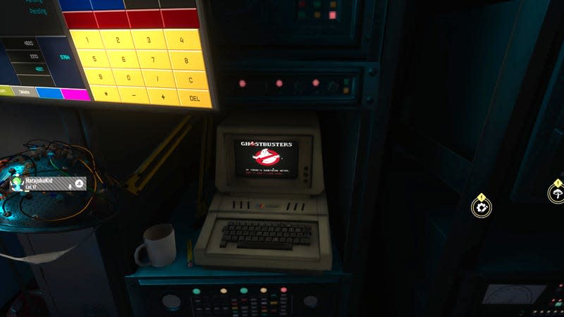 A computer resembling old, early Apple II models displays the Ghostbusters logo and underneath, in barely legible text, words from the song "Ghostbusters" by Ray Parker, Jr.