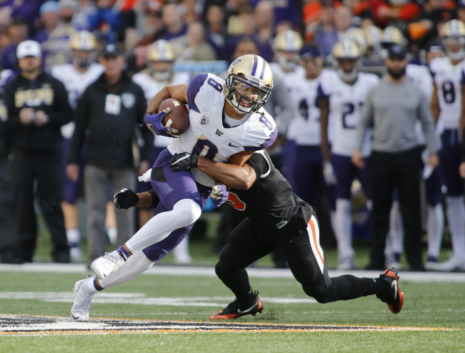 Washington wide receiver Dante Pettis (8) breaking a tackle after making a catch in the first half of an NCAA college football game against Oregon State, in Corvallis, Ore. (AP Photo/Timothy J. Gonzalez, File)