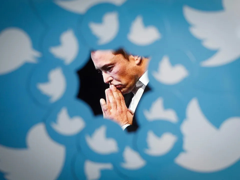 An image of new Twitter owner Elon Musk is seen surrounded by Twitter logos in this photo illustration.