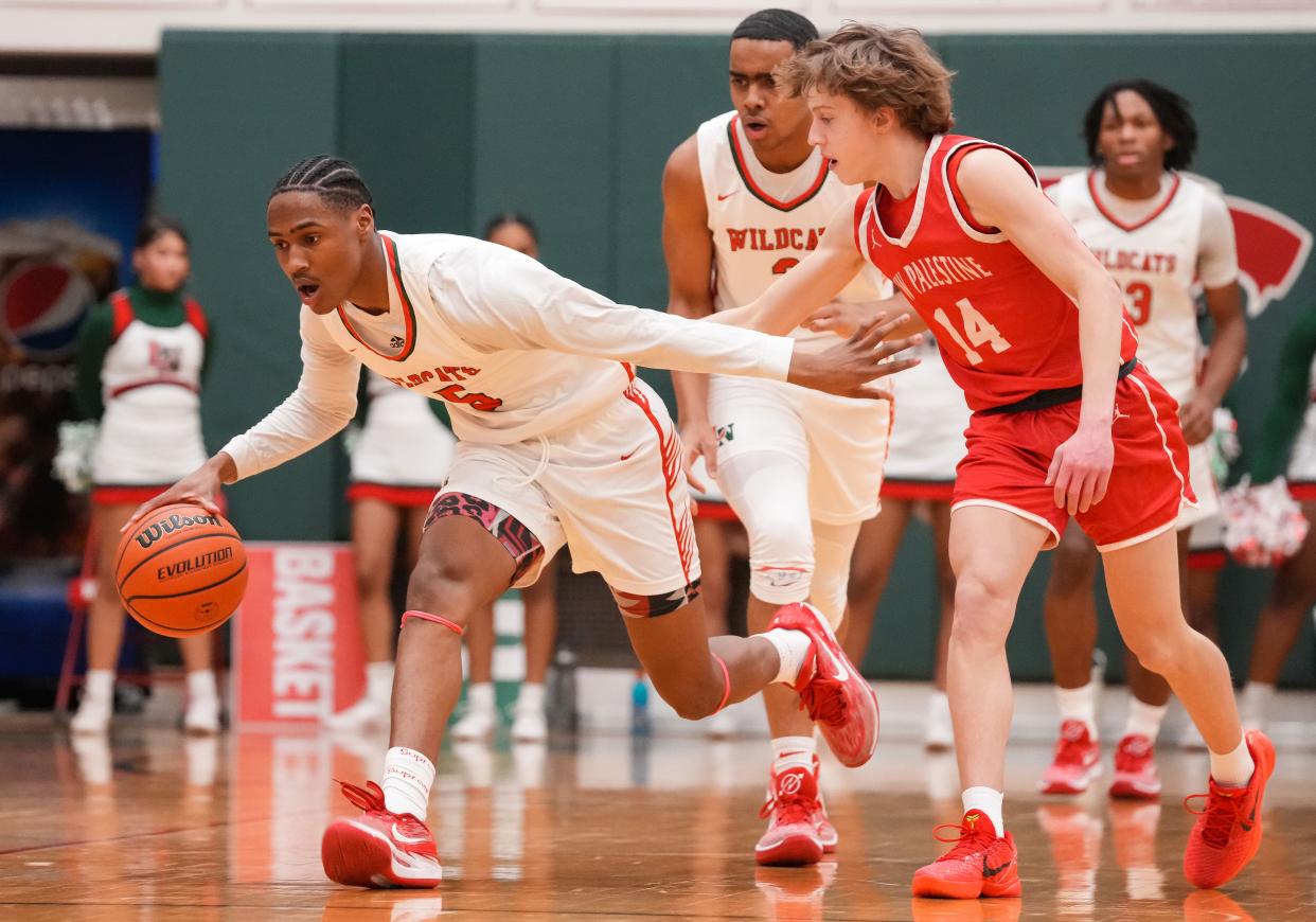 Lawrence North Wildcats Jamar Thomas (5) rushes up the court against New Palestine Dragons Evan Darrah (14) on Wednesday, Jan. 24, 2024, during the game at Lawrence North High School in Indianapolis. The Lawrence North Wildcats defeated the New Palestine Dragons, 57-48.