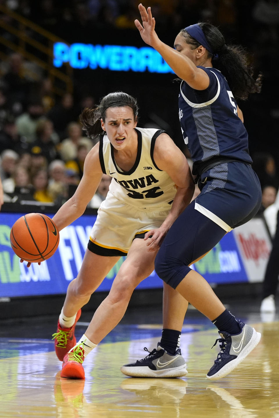 Iowa guard Caitlin Clark (22) drives around Penn State guard Leilani Kapinus (5) during the first half of an NCAA college basketball game, Thursday, Feb. 8, 2024, in Iowa City, Iowa. (AP Photo/Charlie Neibergall)