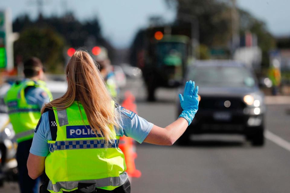 Police man a road block on the outskirts of Auckland as New Zealand's largest city moved to COVID-19 Alert Level 3, Wednesday, Aug. 12, 2020 (AP)