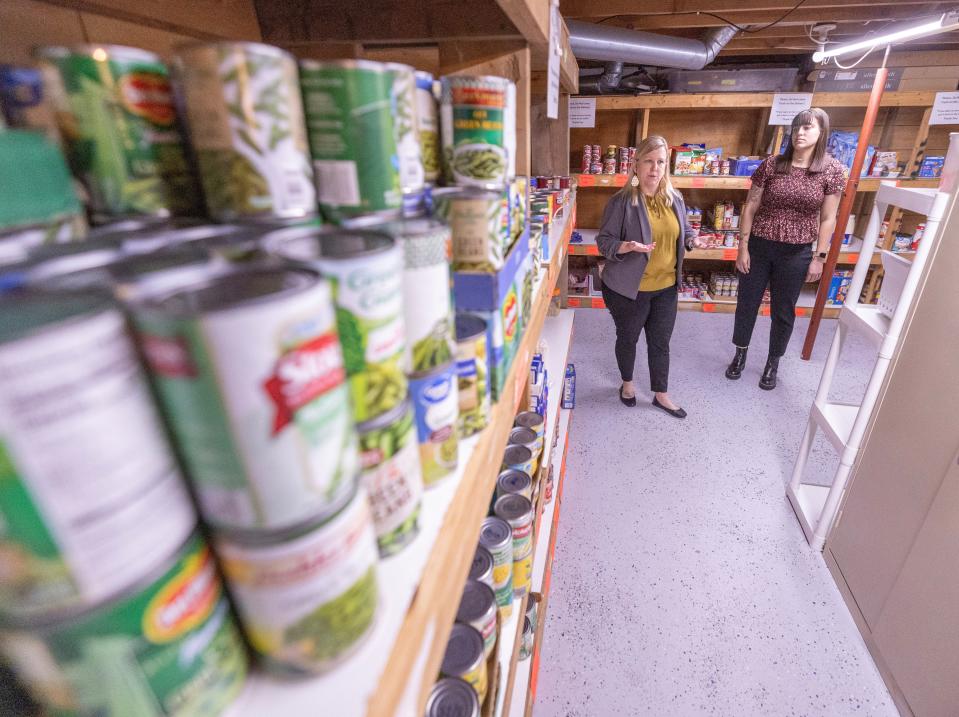 Kristina Drummer, executive director of Alliance Area Domestic Violence Shelter, left, and Hannah Schmid, community engagement specialist at the shelter, talk about the facility's foodbank on Thursday, April 18, 2024.