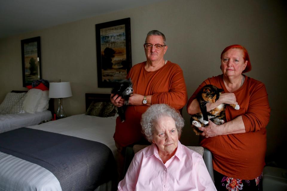 Dennis and Denise Schlies, and Shirley Hoover pose for a portrait with their pets Guni the dog and Savannah the cat on Tuesday, Sept. 15, 2020 at a hotel in Salem, Oregon. The family lost their home during the wildfire in Gates, Oregon.