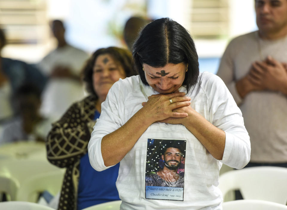 A woman cries during a tribute to those who died in the dam disaster last year in Brumadinho city, Minas Gerais state, Brazil, Saturday, Jan.25, 2020. The rupture of mining company Vale’s dam in 2019 remains raw in a town of 40,000 people that’s trying to lift itself up after the blow.(AP Photo/Gustavo Andrade)