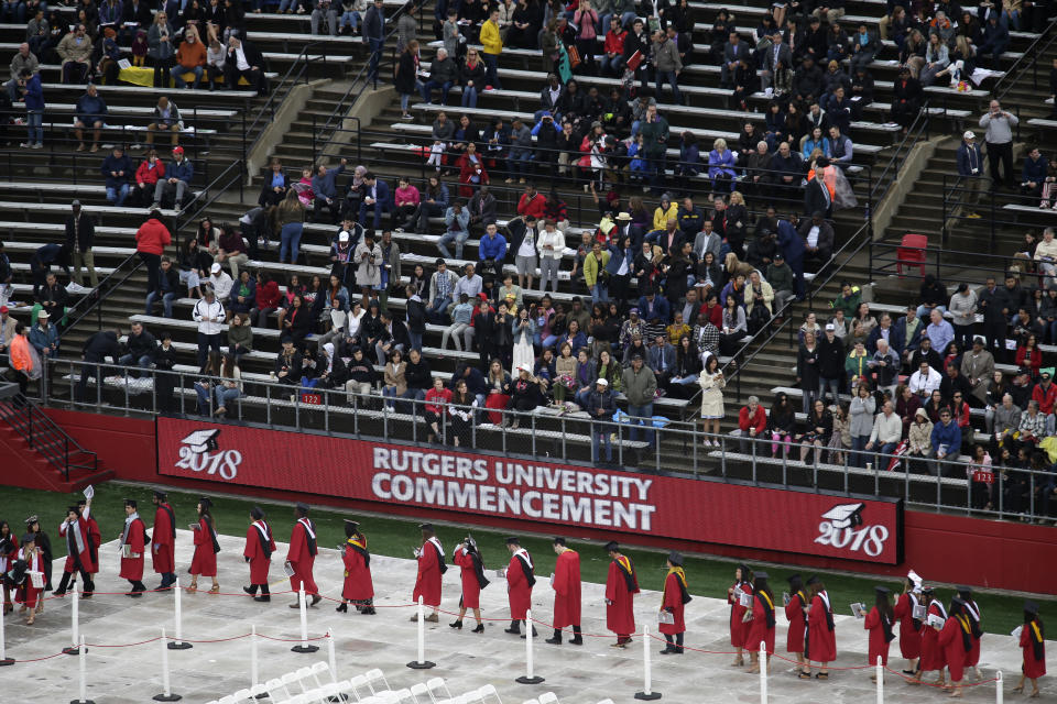 <p> FILE - In this May 13, 2018, file photo, new graduates walk into the High Point Solutions Stadium before the start of the Rutgers University graduation ceremony in Piscataway Township, N.J. A growing number of colleges and universities are postponing tuition deadlines, waiving late fees and providing emergency grants to students whose finances have been tied up by the longest government shutdown in history. Among the latest to advertise help are Brown University, Rutgers University and the State University of New York system. (AP Photo/Seth Wenig, File) </p>